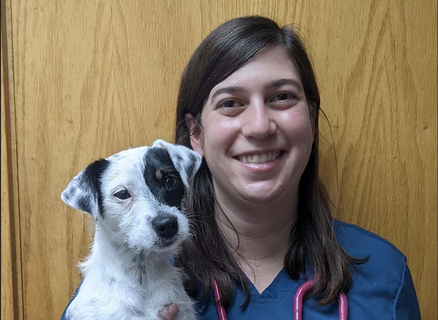 Dr. Kyle Fuller poses with a dog who fortunately does not reverse sneeze