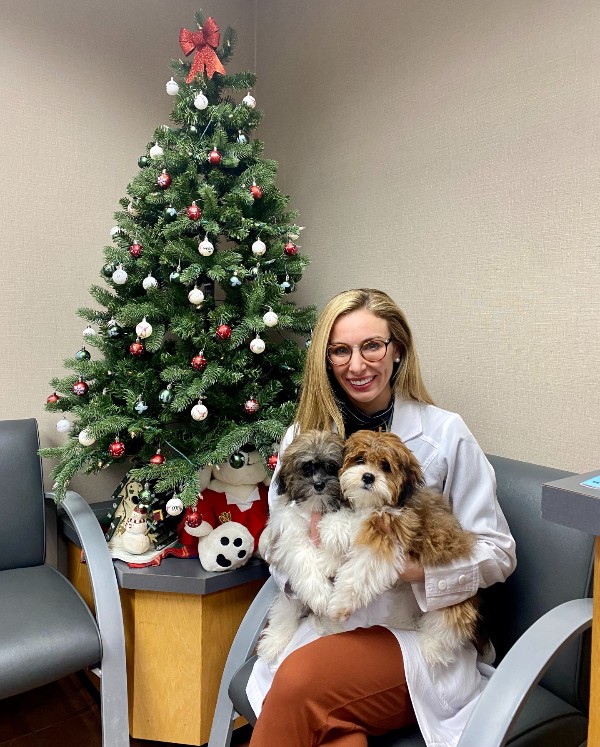 Dr. Buffa poses with two patients.