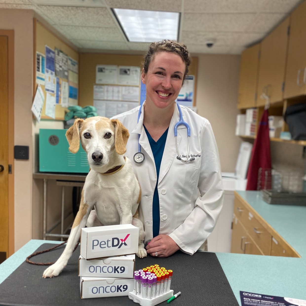 Dr. Schaffer and Jax pose with cancer-detecting blood test OncoK9.