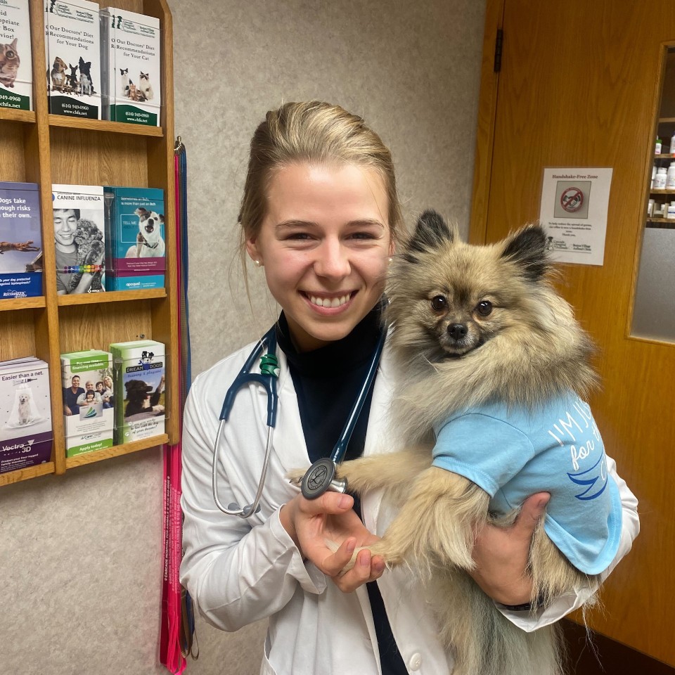 Dr. Grace Longcore smiles with a Pomeranian patient.