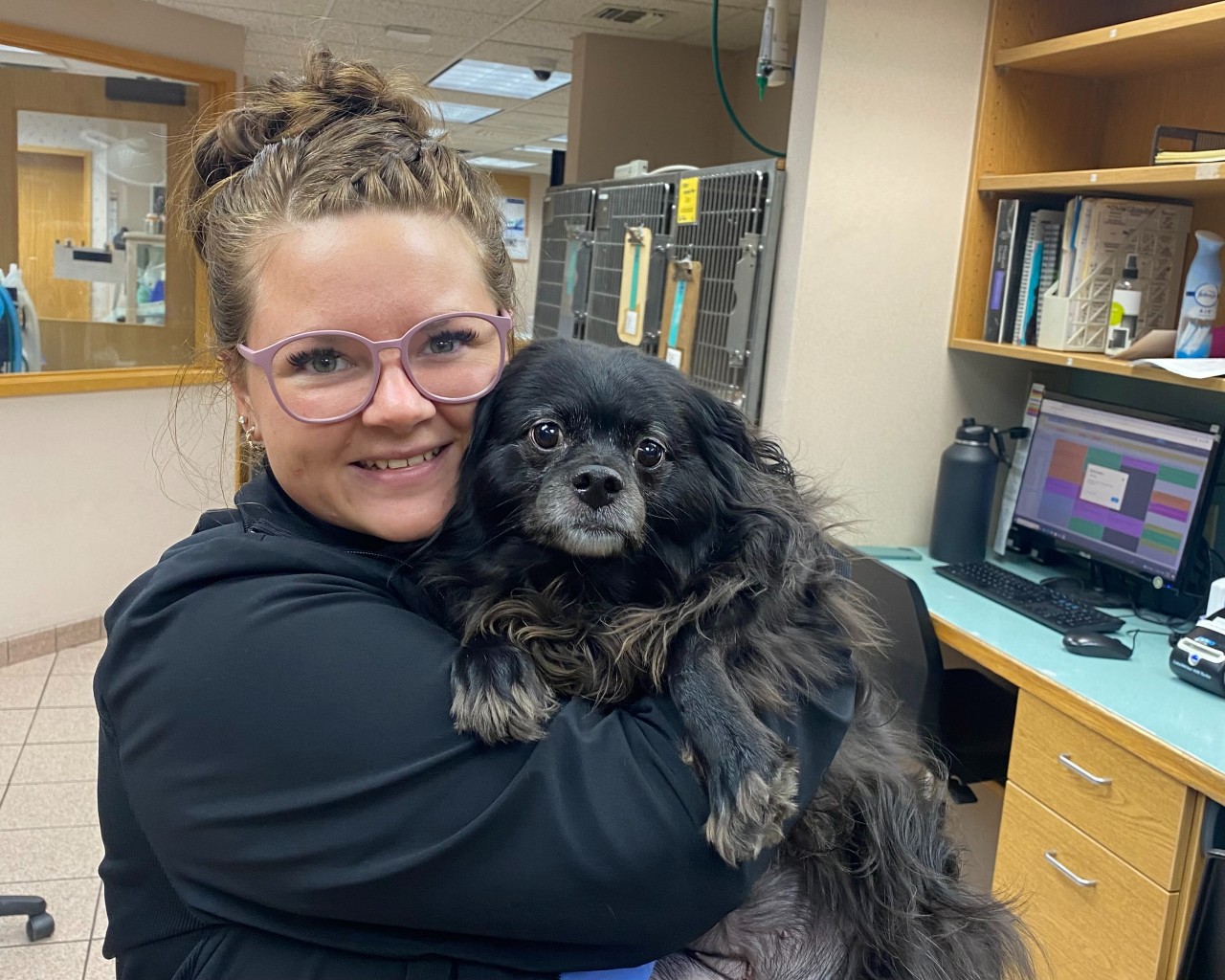 Licensed Veterinary Tech Aly holds Rosey, who recovered from bladder stone removal surgery.