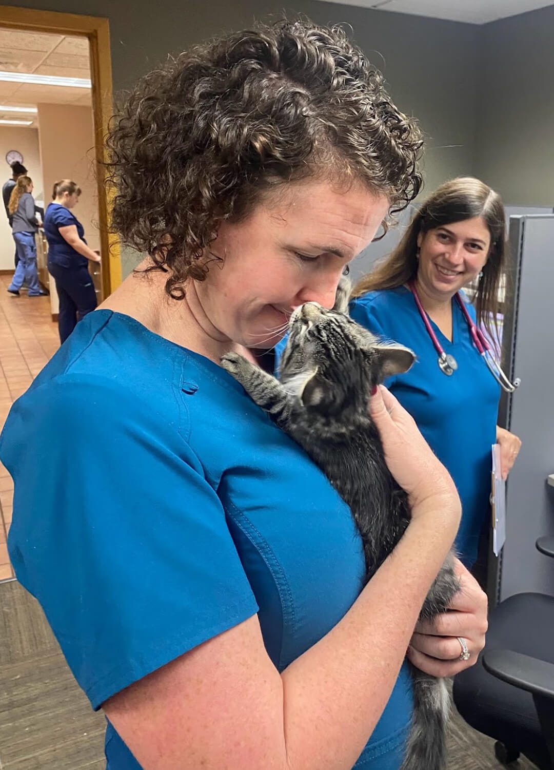 female vet getting kitten kisses